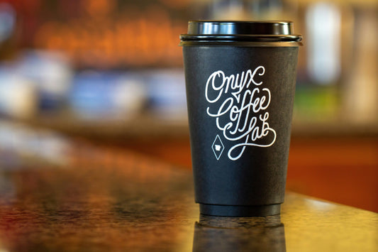 A black and silver coffee cup