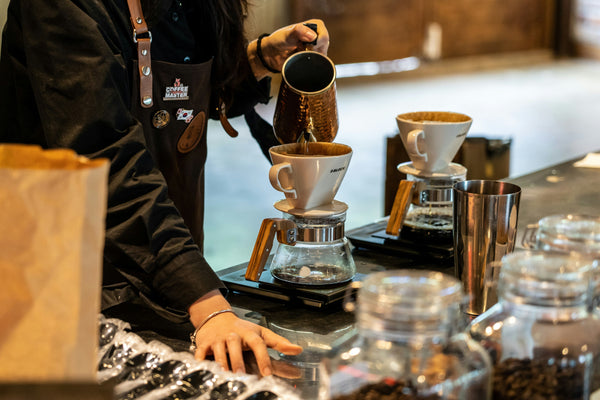 A barista pouring coffee into a cup, photo by Choi Sungwoo on Unsplash
