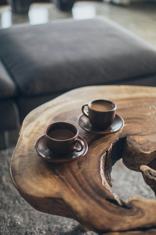 Two cups of coffee on a wooden table