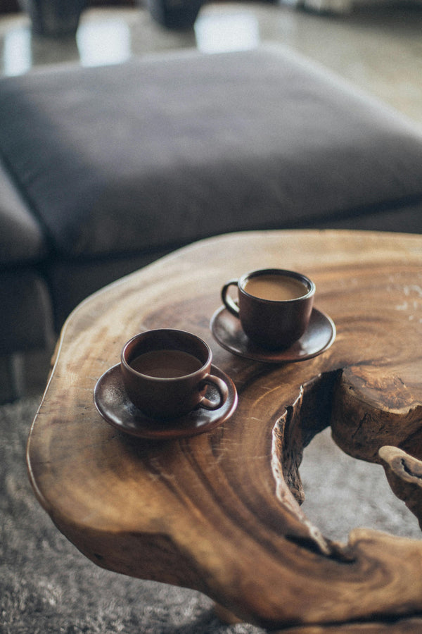 Two cups of coffee on a wooden table