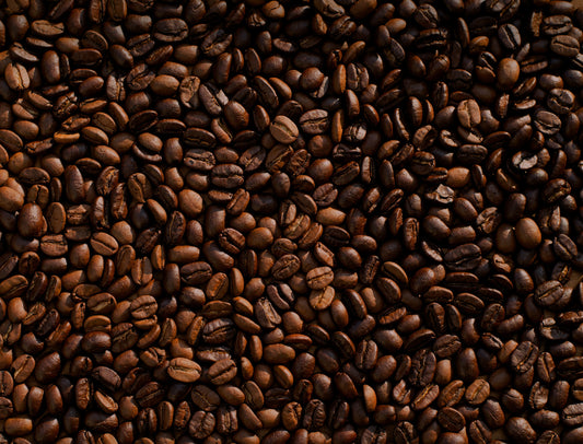 Raw coffee beans scattered across a surface