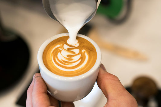 Milk being poured into a cappuccino