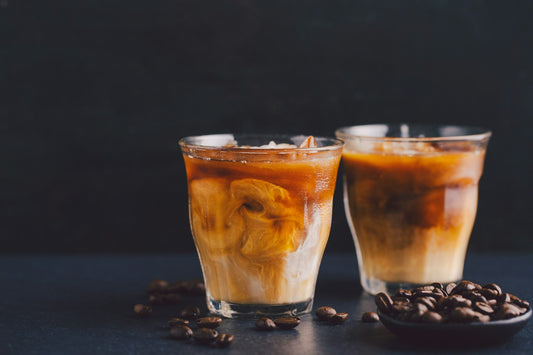 Two glasses of iced coffee on a table