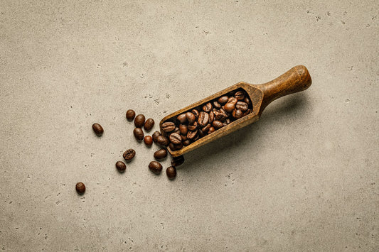A wooden scoop filled with roasted coffee beans