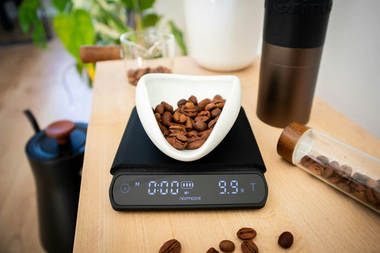Coffee beans being weighed on a digital kitchen scale before brewing