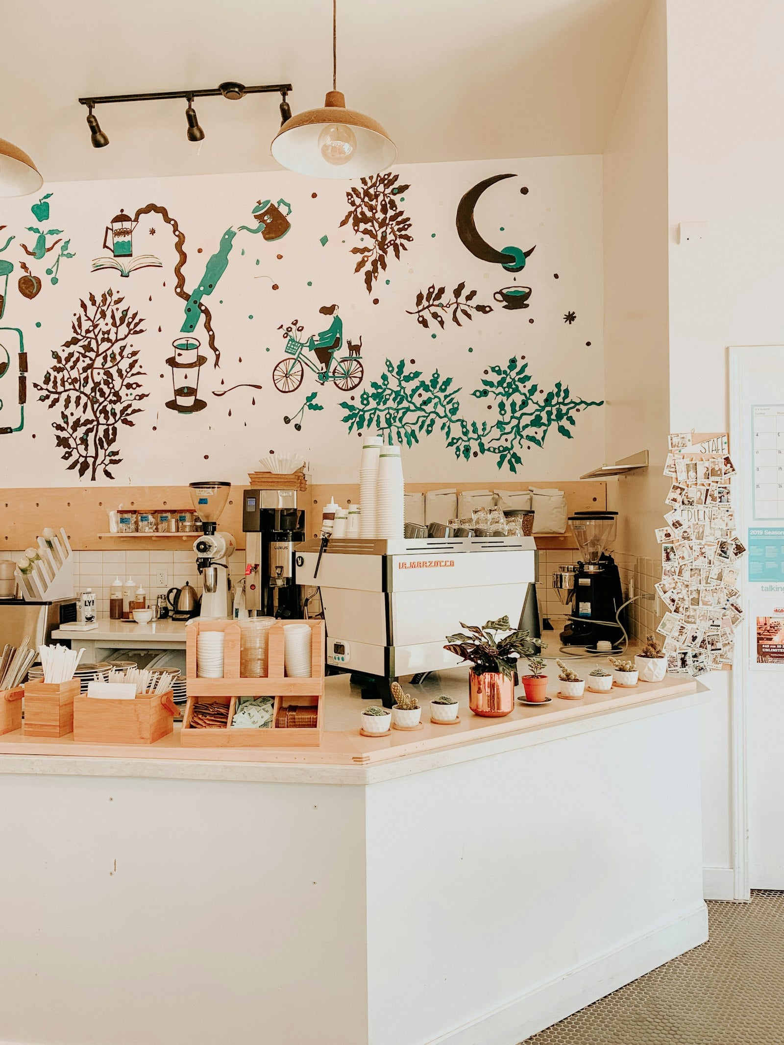 Containers on a white wooden kitchen counter at a coffee shop