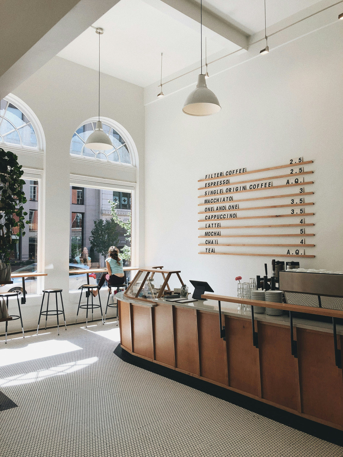 Bright modern coffee shop interior with curved counter