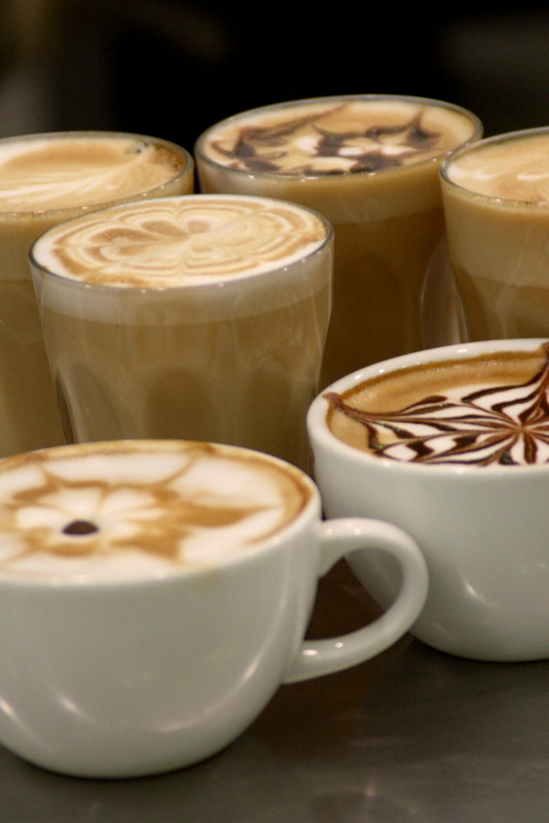 Several cups of coffee with latte art
